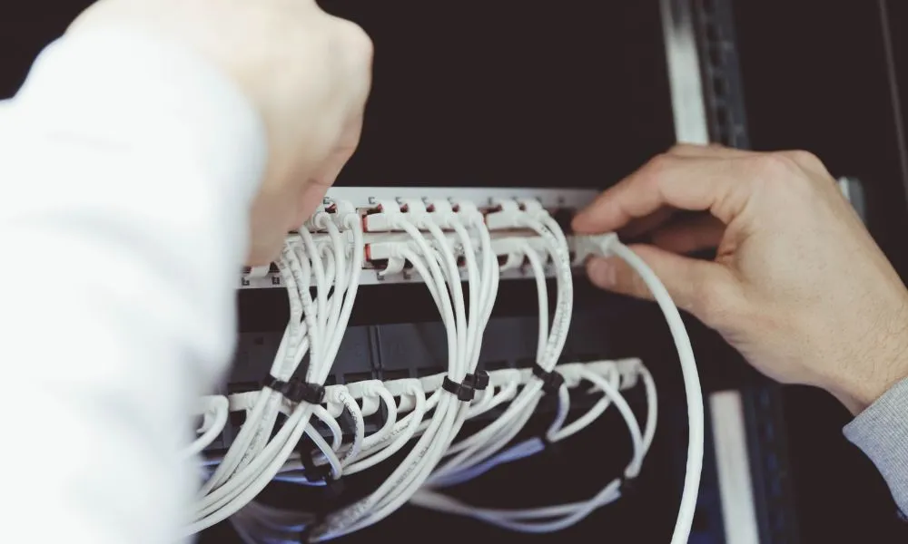 En elektriker på Nørrebro arbejder professionelt med en server for at sikre optimal drift og pålidelighed.